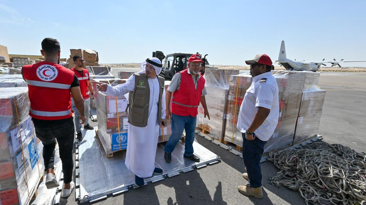 Officials checking food and medical supplies unloaded at Al Arish air base in Egypt.