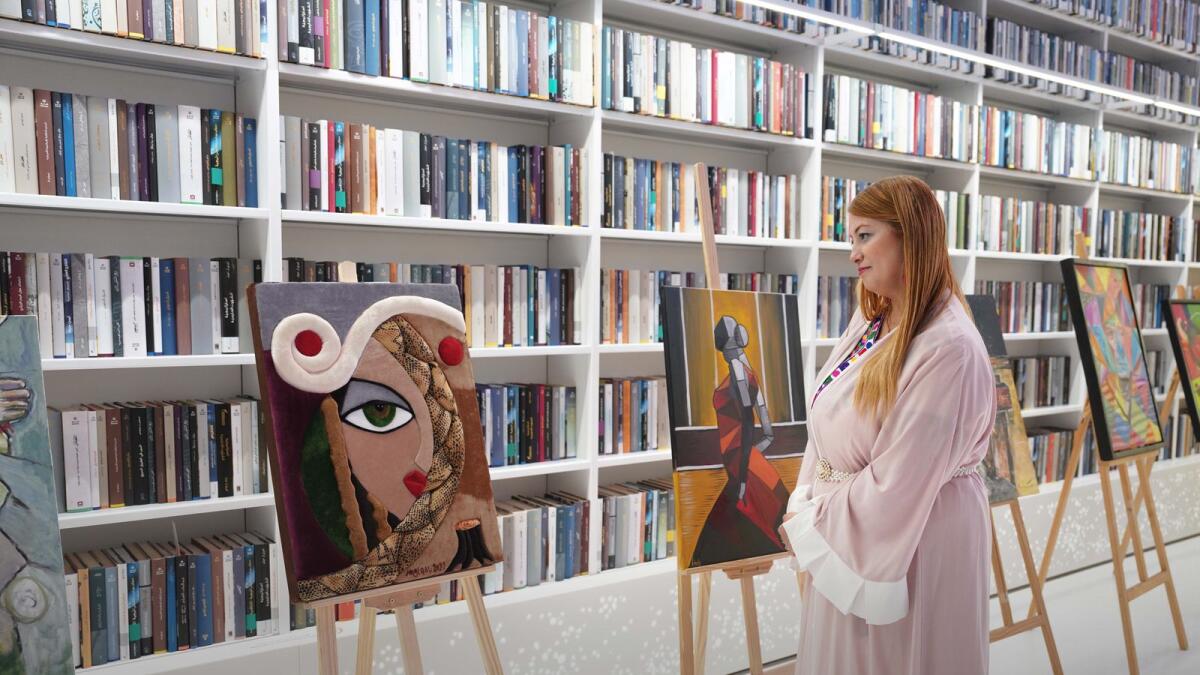 A visitor looks at paintings on display at the Mohammed Bin Rashid Library as part of the Picasso Days.  —Wam