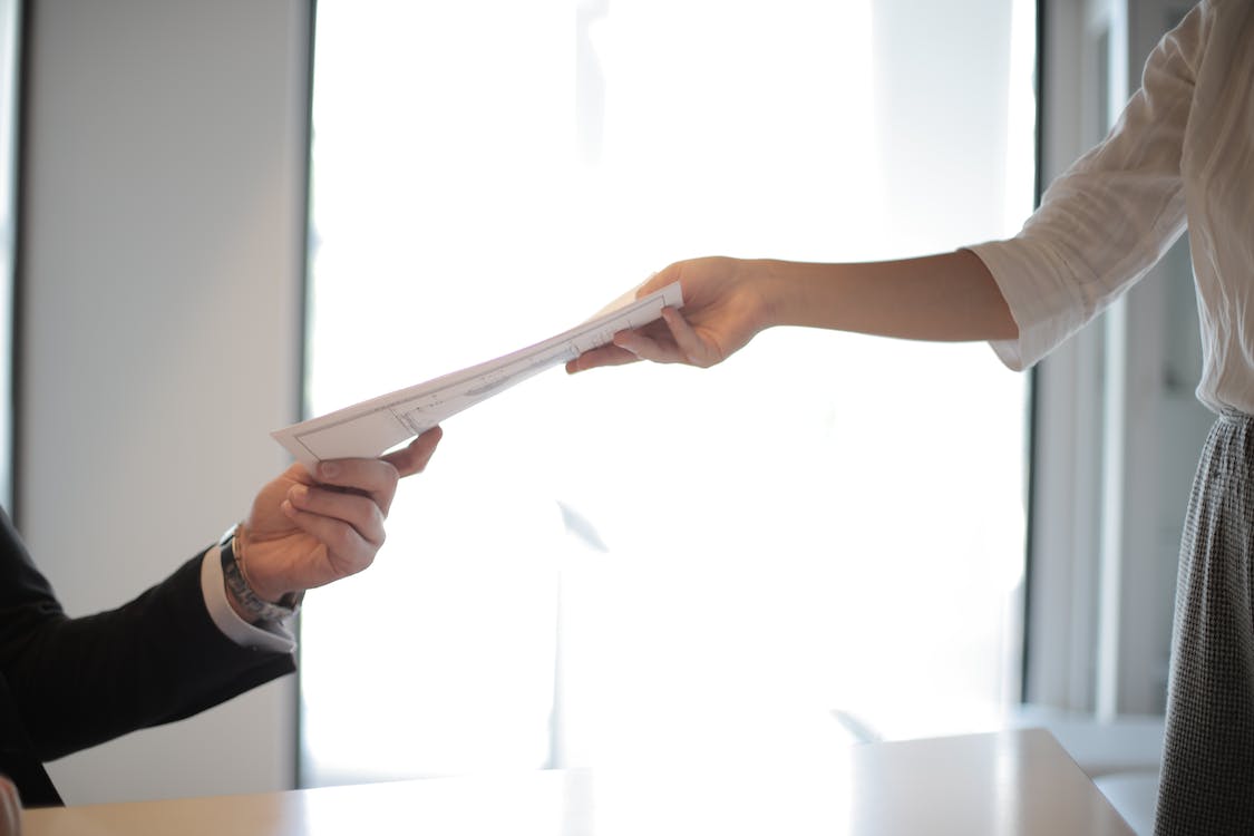 Free Job applicant passing his documents Stock Photo