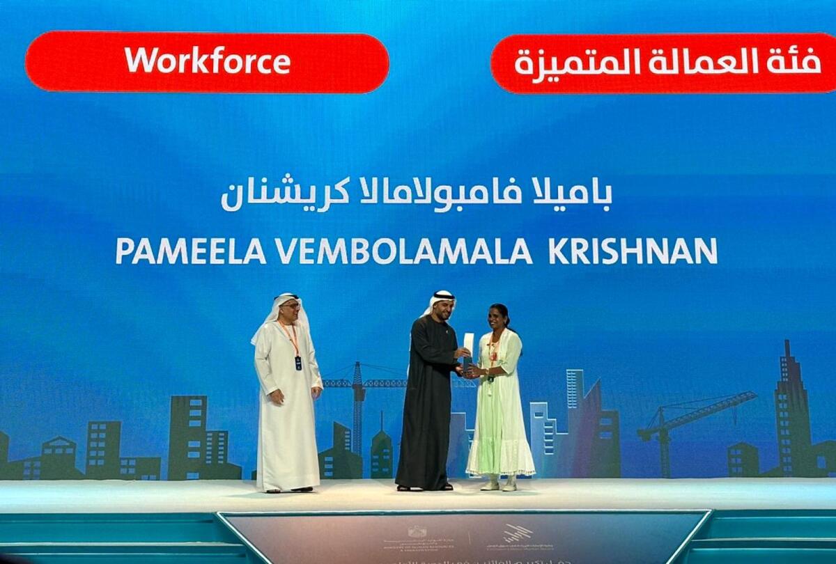 Pameela Vembolamala Krishnan receives the award from Sheikh Mohammed bin Hamad bin Tahnoon Al Nahyan, Special Affairs Advisor to the Presidential Court, and MoHRE Minister Dr. Abdulrahman Al Awar (Photo: Angel Treasurer/Khaleej Times)