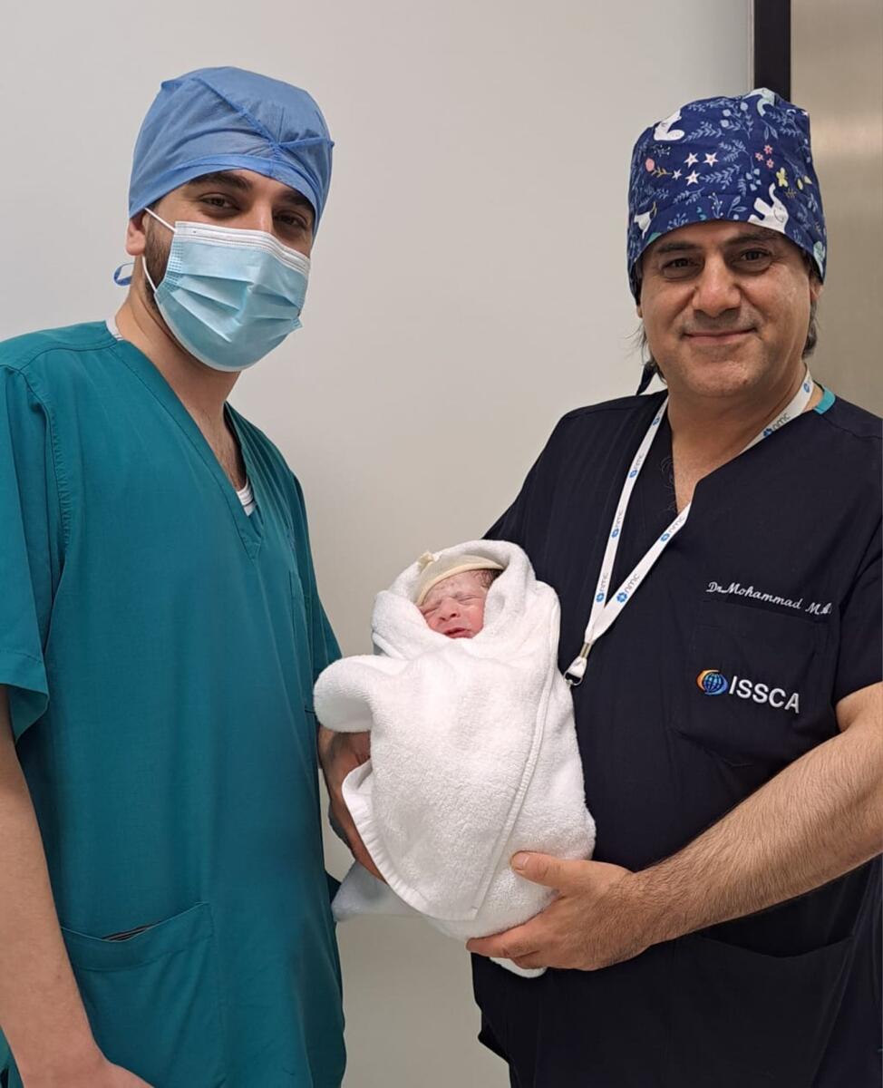 Photo: Dr. Mohammad Al Hassoun with father Murad and baby Zeina