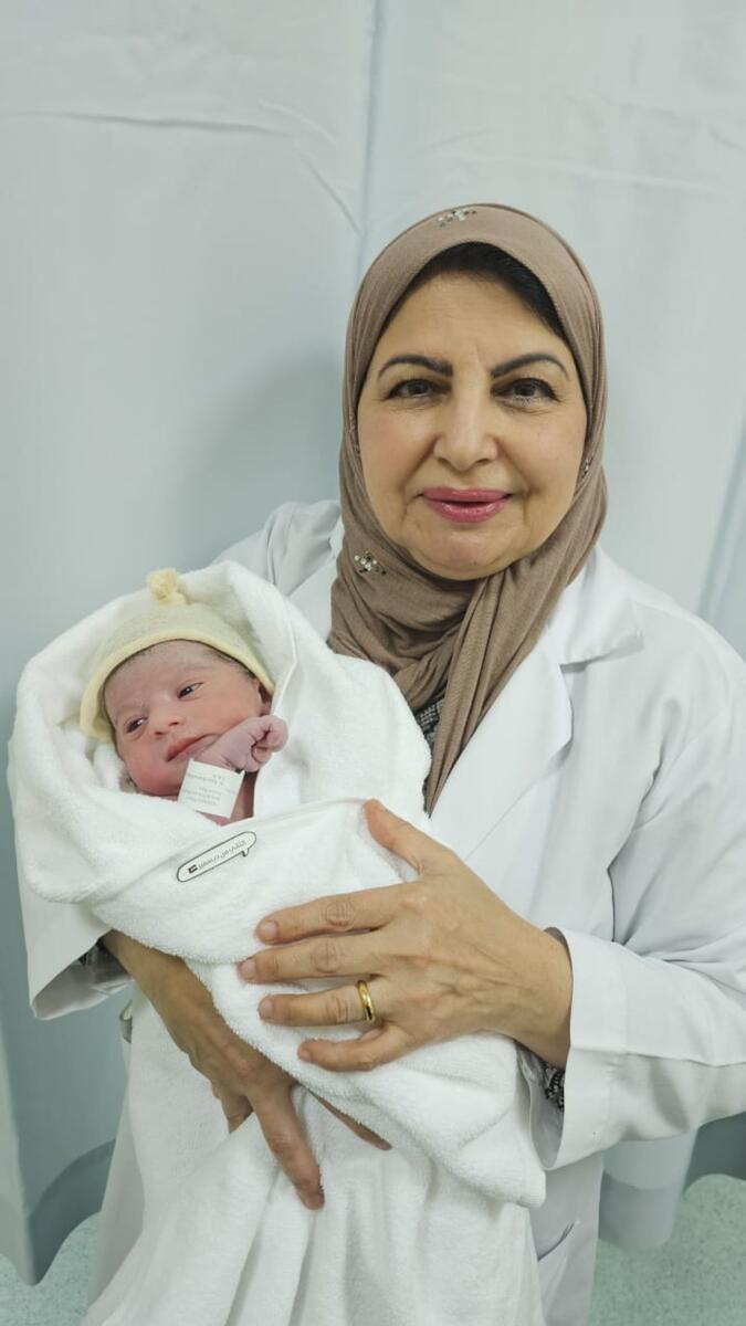 Photo: Dr. Rabab Helmy holding baby Mazna