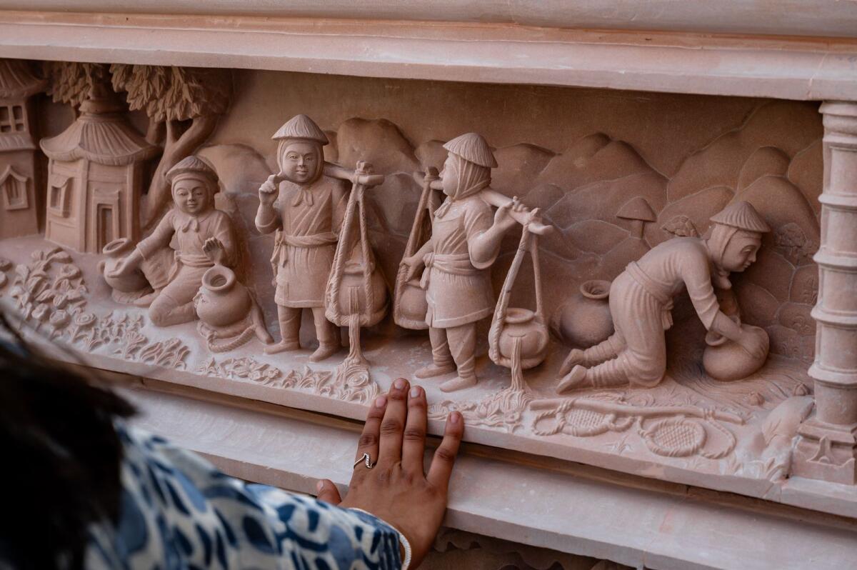 Detailed view of stone carvings depicting stories from Hindu scriptures.
