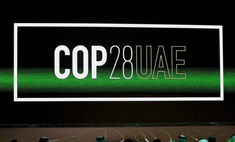 The Cop28 UAE logo is displayed on screen during the opening ceremony of Abu Dhabi Sustainability Week (ADSW).  — Stock Photo