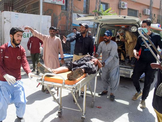 Volunteers carry a blast victim on a stretcher at a hospital in Quetta