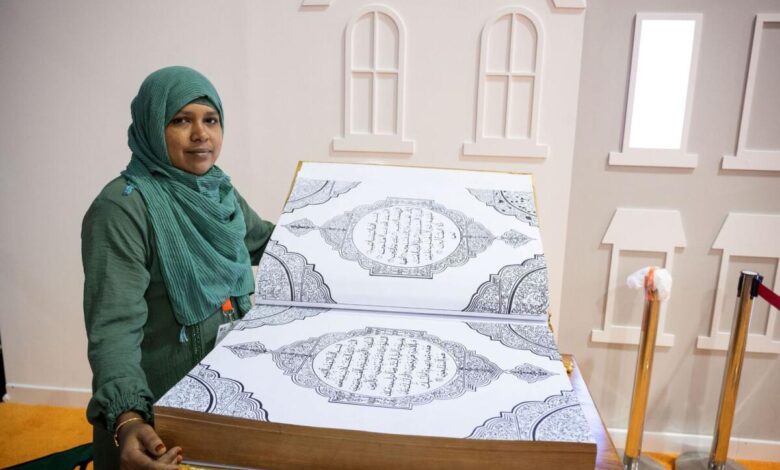 Jaleena with handwritten calligraphic Holy Quran at SIBF 2023. Photo: Supplied