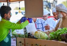 Consumers buy vegetables at a stand at the Al Dhaid Agricultural Exhibition.