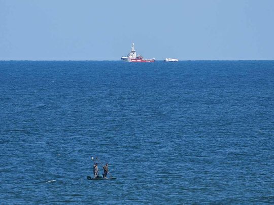 A ship belonging to the Open Arms aid group approaches the shores of Gaza towing a barge with 200 tons of humanitarian aid on Friday, March 15, 2024.